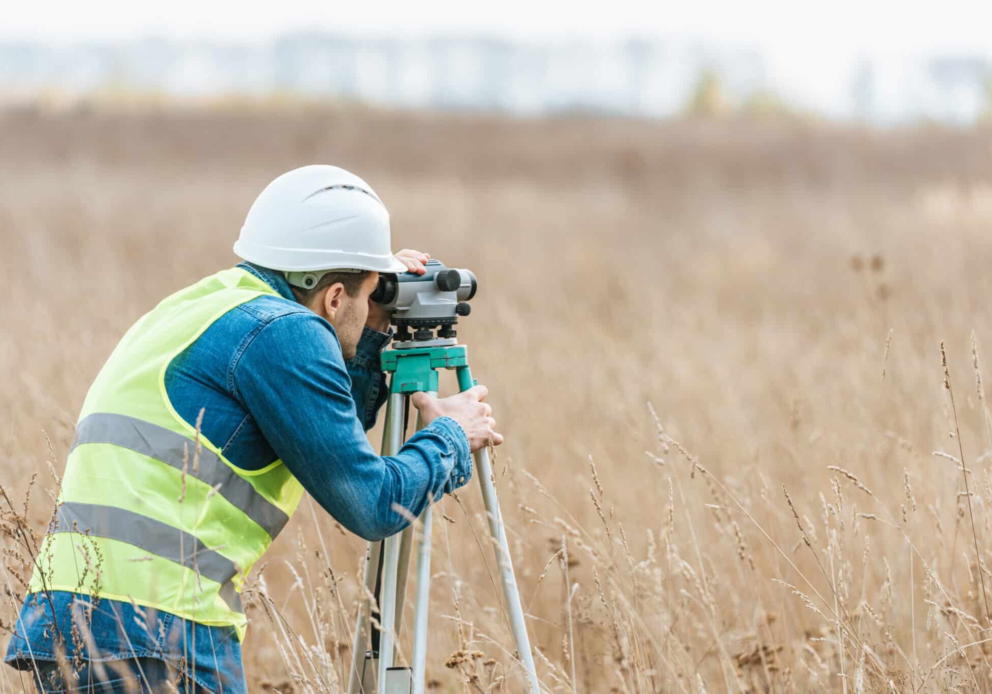 Surveyor with digital level working in field